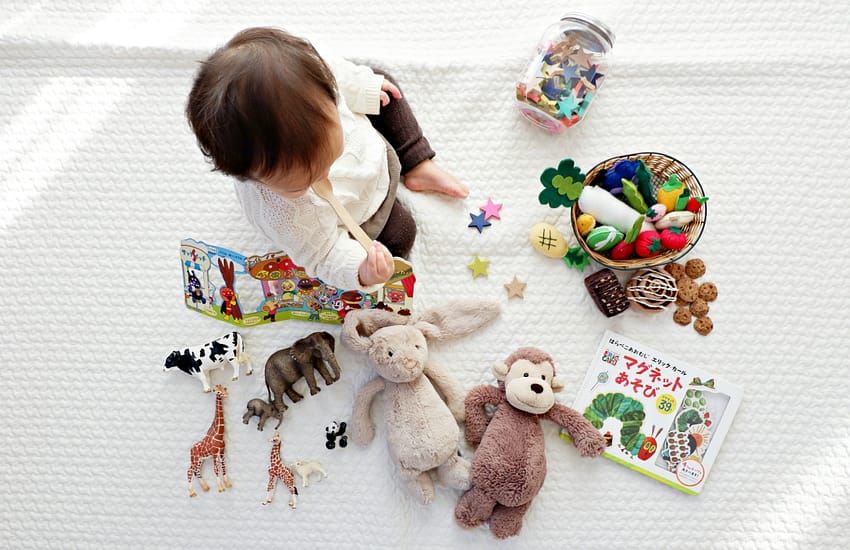 toddler paying with toys